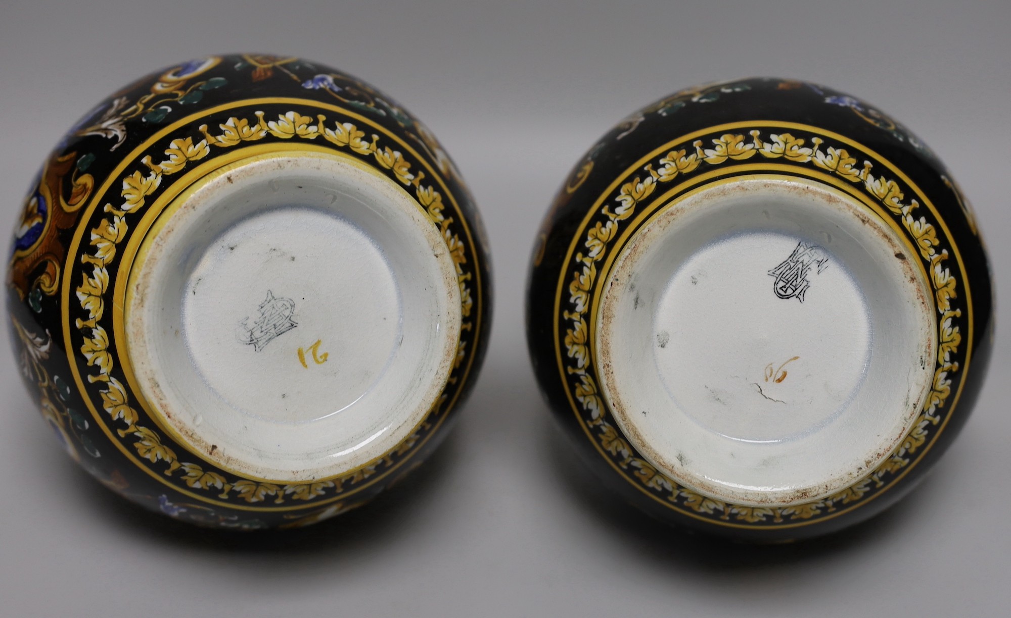 A pair of French maiolica ewers, 22cms high